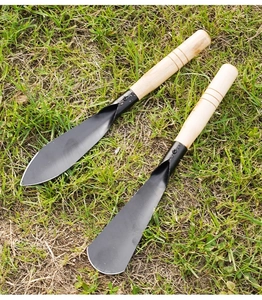 Two-piece garden tool set with sharp and flat spades on grass, featuring wooden handles