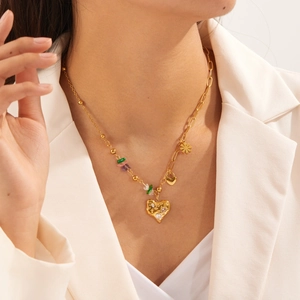 Close-up of gold-plated stainless steel necklace with heart pendant and colorful stones