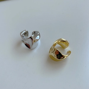 Macro shot of gold and silver irregular textured rings featuring unique crinkled surface
