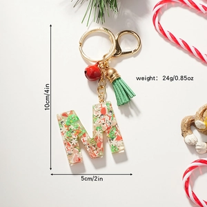 Christmas letter M resin keychain with festive sequins, green tassel and a small red bell