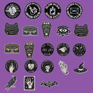 Gothic punk enamel pin set featuring horror themes and dark aesthetic on purple backdrop