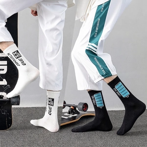 Athletic crew socks in black and white with street style logo prints for skateboarding