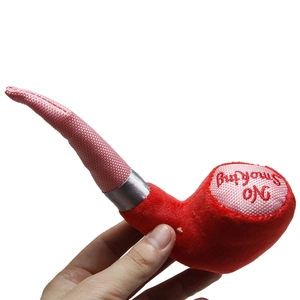 Detail view of a red pipe shaped plush toy featuring white No Smoking embroidery