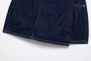 Close-up of deep blue denim fabric texture and durable double-stitch seam details