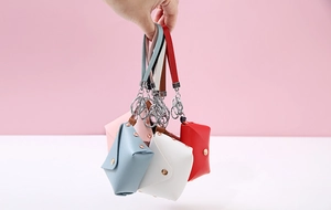 Detailed view of colorful PU leather mini wallets with keychains in various colors