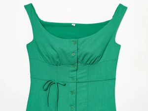Detail of green linen sleeveless dress featuring square neck and single-breasted buttons