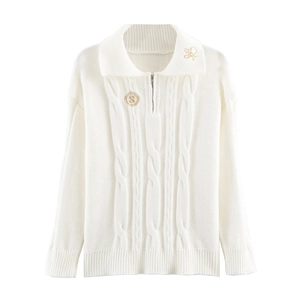 White cable-knit quarter-zip polo sweater with gold embroidered badge on flat white background