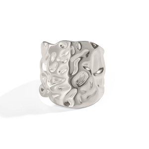 Macro shot of silver stainless steel ring with unique geometric wrinkled hammer texture