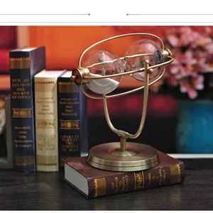 European vintage bronze rotating hourglass decor with white sand on a book base