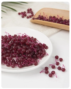 Macro view of miniature resin cherries for DIY cakes and miniature crafts decoration