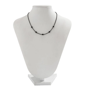 Detailed close-up of a vintage black beaded choker necklace on a white neck model