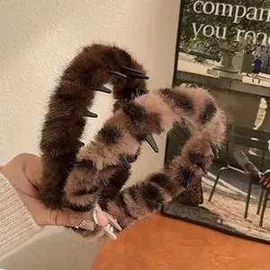 Detail of plush faux fur claw clips in solid brown and leopard pattern for winter styling