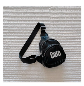 Detail of a black synthetic leather kids chest bag with white Cute letter print