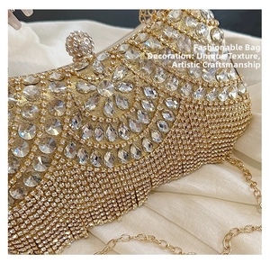 Macro shot of gold rhinestone evening clutch with crystal floral patterns and tassels