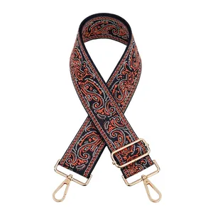 Close-up of adjustable paisley jacquard bag strap with gold metal swiveling hooks