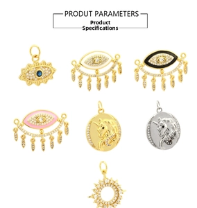 Detailed view of gold plated evil eye, sun, and unicorn charms with cubic zirconia