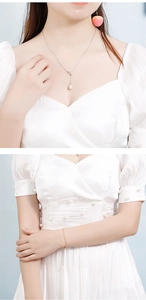 Detailed close-up of a pearl tassel necklace with matching peach earrings and bracelet