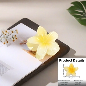Detailed macro view of small 4cm plumeria hair clip with soft yellow gradient finish