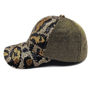 Detail of sequin leopard print baseball cap with shimmering gold and black patterns