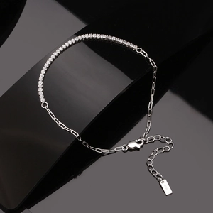 Detail of s925 silver bracelet featuring cubic zirconia tennis chain and paperclip links