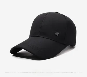 Detail of black cotton baseball cap showing side metal Z emblem and reinforced brim stitching