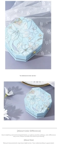 Detail of light blue octagonal wedding candy box with floral patterns and gold metal clasp