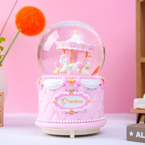 Dreamy pink carousel crystal ball music box with snow effect and golden Dream letters