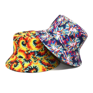 Detail view of tie-dye bucket hats in yellow, orange, blue and pink canvas fabric