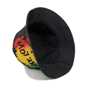 Detail of a black bucket hat with "ONE LOVE" text and Rasta color gradient print.