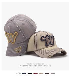 Detail of vintage canvas baseball caps with 3D letter W embroidery and distressed brims