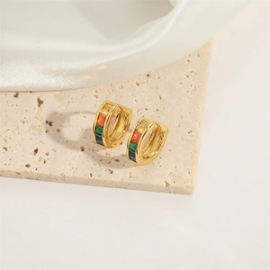 Detail of gold U-shaped hoop earrings with colorful rainbow cubic zirconia stones