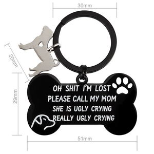 Detail view of dog bone keychain with sizes 51x29mm and funny engraved text on metal