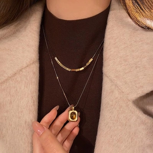 18k gold plated double-layer necklace set with oval brown tiger eye pendant on model