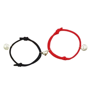 Matching heart magnetic charms on red and black braided friendship bracelets