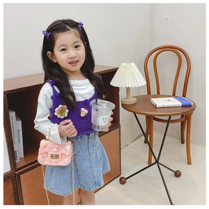 Pink quilted chain crossbody bag for girls with pearl handle in a cozy home setting