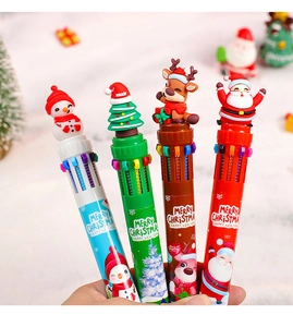 Close-up of 10-color shuttle pens with silicone Christmas toppers held in hand