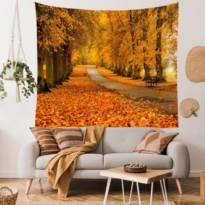 Detail of a forest tapestry with golden autumn landscape hung above a sofa in a modern room