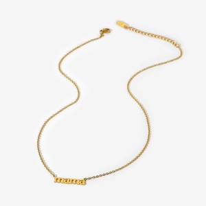 Detailed macro view of gold plated stainless steel necklace with mama letter pendant