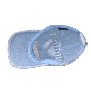 Interior detail of washed denim cap showing cotton label and high-quality lining structure