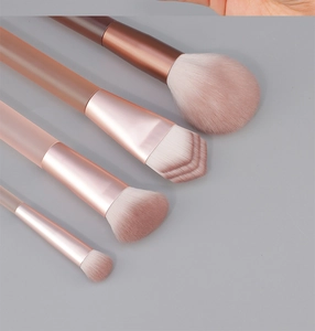 Close-up of soft pink synthetic bristles and rose gold ferrule on makeup brushes