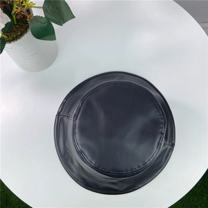 Close-up of black PU leather bucket hat with fine matte texture and neat stitching details