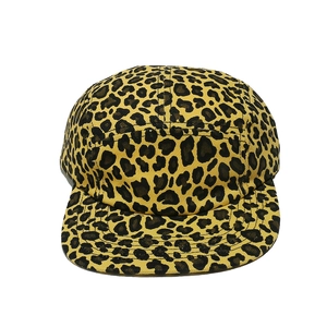 Macro detail of high-quality leopard print canvas fabric on a five-panel camper cap