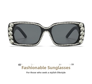 Detail of oversized black square sunglasses with sparkling white rhinestones on the frame