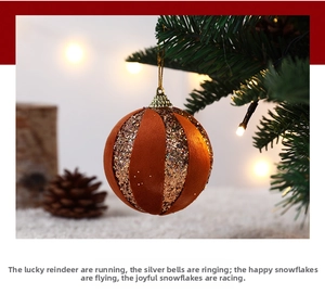 Close-up of velvet and glitter striped Christmas ornament hanging on a festive tree