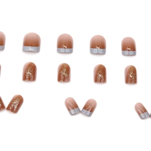Short square press-on nails with amber caramel gradient, gold foil and blue-grey French tips