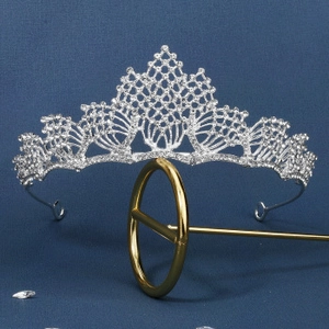 Close-up of Baroque silver bridal crown with intricate hollow design and white rhinestones
