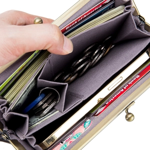 Vintage leather kiss-lock wallet showing large capacity storage and multiple compartments