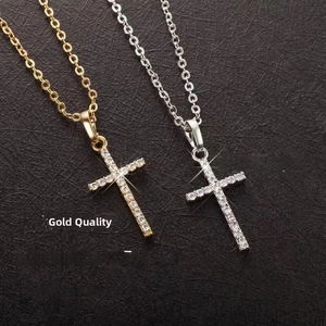 Detailed close-up of gold and silver cross necklaces with micro-pave cubic zirconia