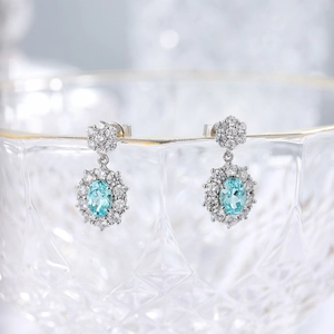 Elegant 925 silver drop earrings featuring oval light blue Paraiba gemstones with halos