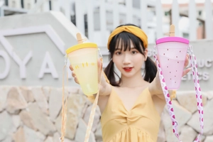 Detail of pink and yellow popsicle-shaped water bottles with patterned shoulder straps